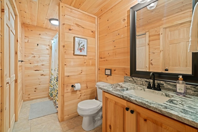 bathroom with tile patterned floors, vanity, wooden ceiling, toilet, and wood walls