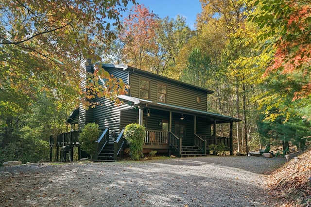 log home featuring a porch