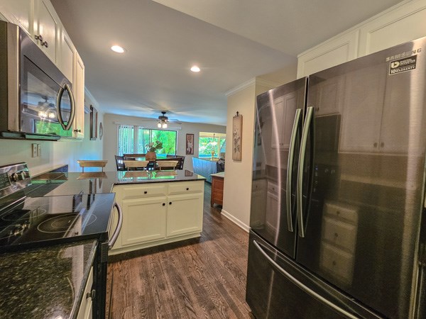 kitchen with ceiling fan, appliances with stainless steel finishes, dark wood finished floors, white cabinets, and recessed lighting
