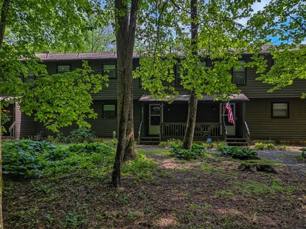back of property with a porch