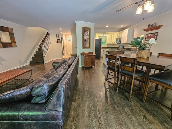 dining room featuring stairway, ornamental molding, a ceiling fan, and dark wood-style floors