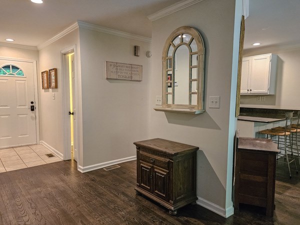 entryway featuring recessed lighting, baseboards, ornamental molding, and wood finished floors