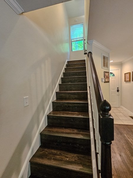 stairway featuring tile patterned flooring