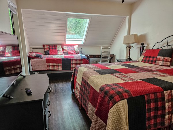 bedroom featuring multiple windows and wood finished floors