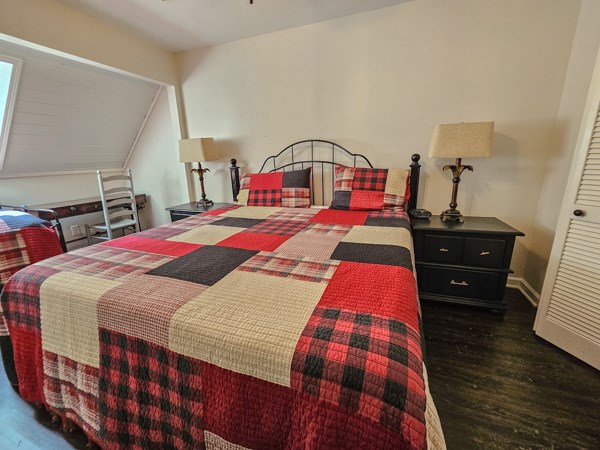 bedroom featuring baseboards and wood finished floors