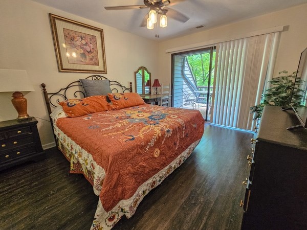 bedroom featuring access to outside, a ceiling fan, wood finished floors, and visible vents