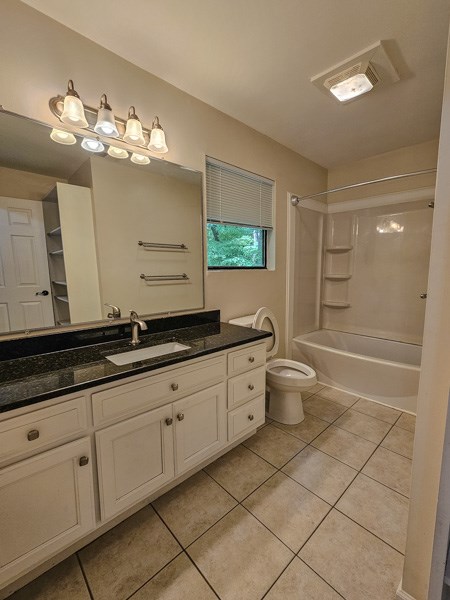 full bathroom with tile patterned flooring, visible vents, vanity, toilet, and shower / washtub combination