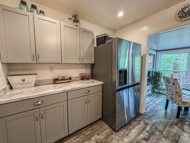 390 Pinebark Ln, Murphy, NC 28906 - kitchen with stainless steel fridge with ice dispenser, gray cabinets, crown molding, dark wood finished floors, and light stone counters