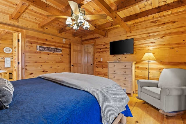 bedroom featuring wooden walls, a ceiling fan, wood ceiling, beamed ceiling, and light wood-type flooring