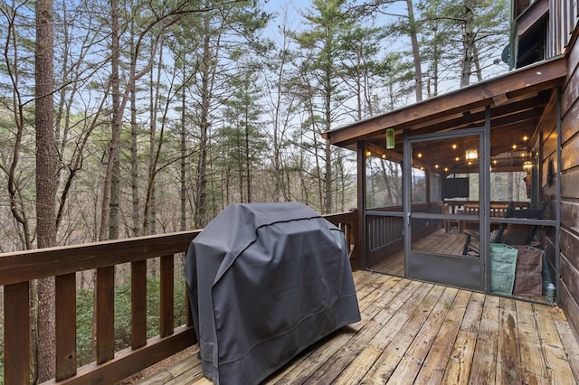 deck featuring a sunroom and grilling area