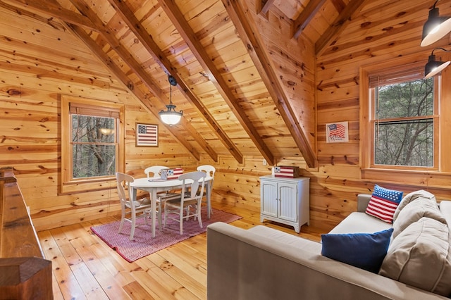 additional living space featuring wood walls, wooden ceiling, vaulted ceiling with beams, and light wood finished floors