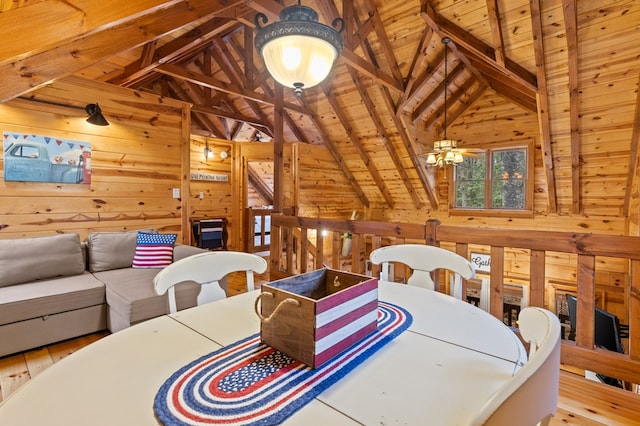 dining space with wooden walls, wood ceiling, wood finished floors, and vaulted ceiling with beams