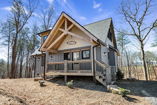 view of front of home featuring a shingled roof, board and batten siding, and a porch