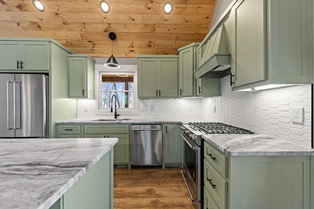 kitchen with dark wood-style floors, high quality appliances, premium range hood, green cabinets, and a sink