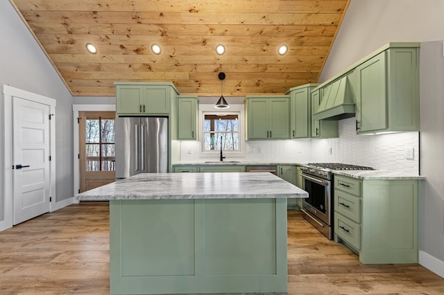 kitchen with custom exhaust hood, light wood finished floors, lofted ceiling, green cabinets, and high quality appliances