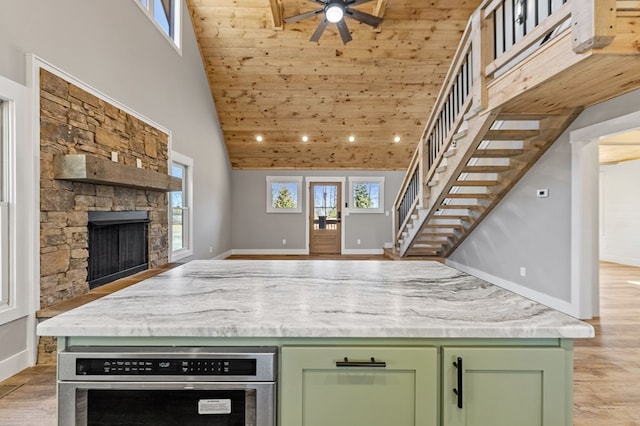 kitchen with green cabinets, open floor plan, and a wealth of natural light