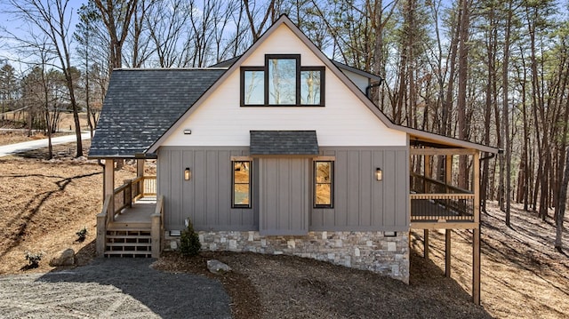 exterior space with roof with shingles and board and batten siding