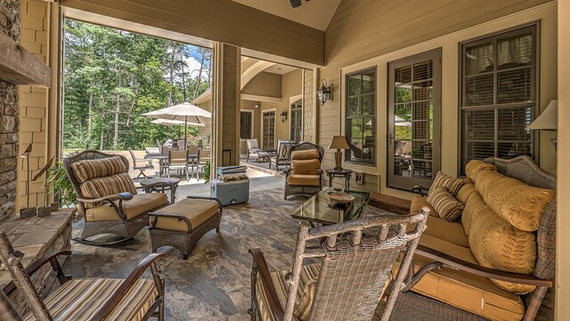 view of patio with an outdoor living space with a fireplace