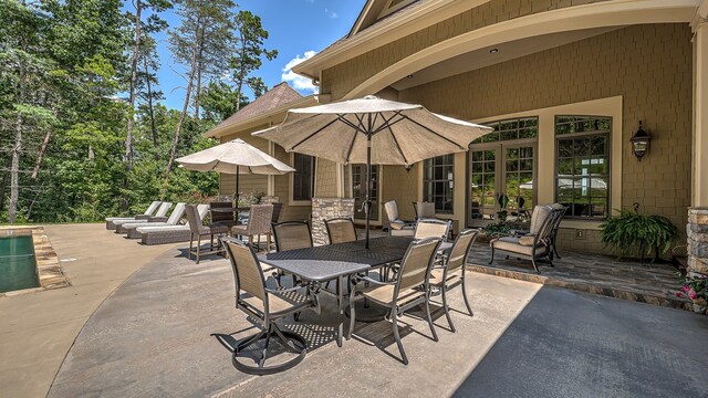 view of swimming pool featuring a patio area, a diving board, and a fenced in pool