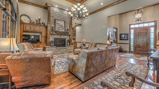 living area featuring ornamental molding, a high ceiling, and wood finished floors