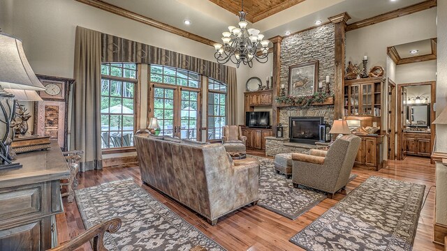 dining area featuring a notable chandelier, a textured wall, light wood finished floors, and baseboards