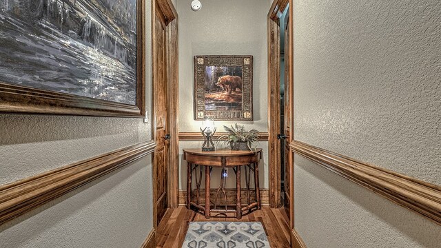 washroom featuring laundry area, crown molding, and light wood finished floors