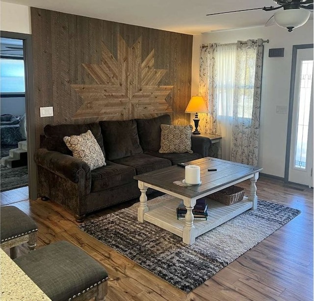 living room with a healthy amount of sunlight, ceiling fan, and hardwood / wood-style floors