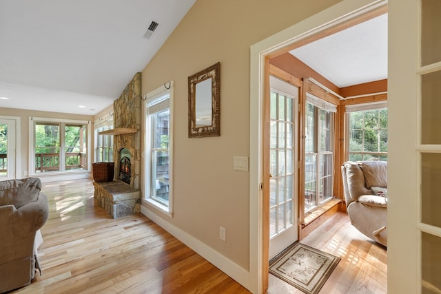 76 Misty River Ln, Hayesville, NC 28904 - living room with vaulted ceiling, light wood-style floors, and a stone fireplace