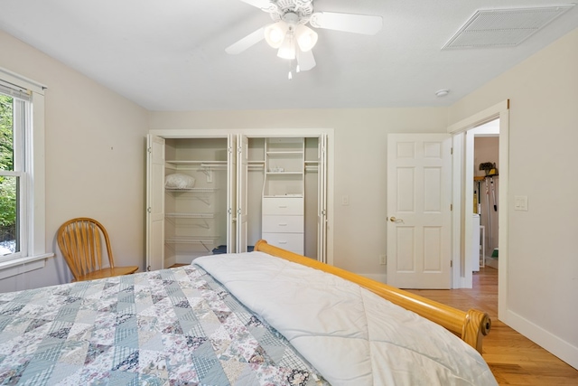 76 Misty River Ln, Hayesville, NC 28904 - bedroom featuring light wood-style floors, two closets, and ceiling fan
