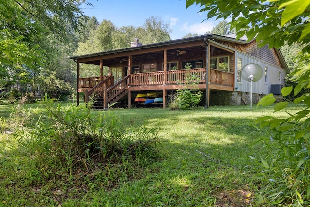 76 Misty River Ln, Hayesville, NC 28904 - rear view of house featuring ceiling fan, a lawn, a wooden deck, a chimney, and stairs