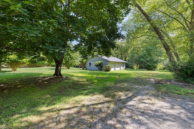 76 Misty River Ln, Hayesville, NC 28904 - view of green lawn featuring a detached garage, an outdoor structure, and a pole building