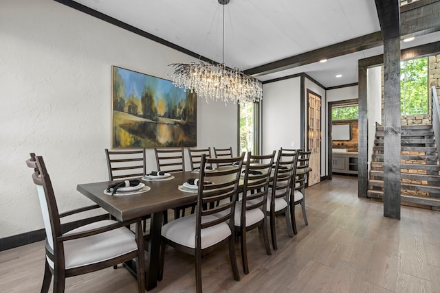 dining space with beamed ceiling, crown molding, a chandelier, and wood-type flooring