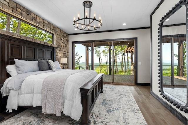 bedroom with ornamental molding, light hardwood / wood-style flooring, a notable chandelier, and access to exterior