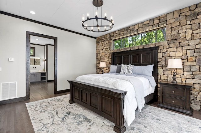 bedroom featuring connected bathroom, crown molding, and hardwood / wood-style flooring