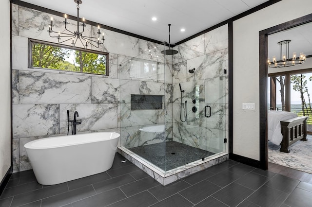 bathroom with tile patterned flooring, tile walls, a chandelier, and shower with separate bathtub