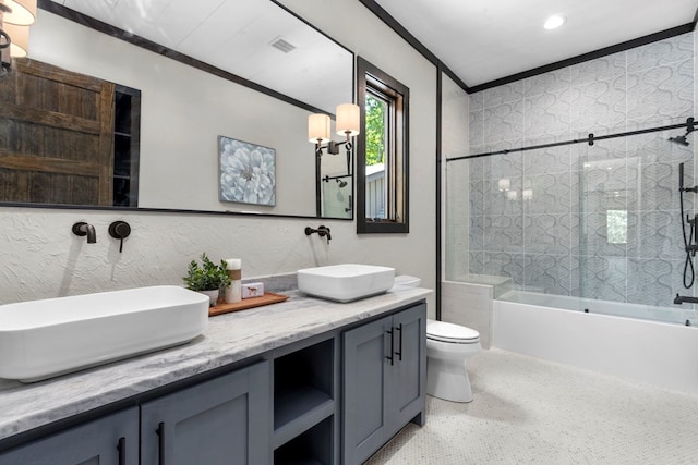 full bathroom with toilet, tiled shower / bath combo, vanity, and ornamental molding