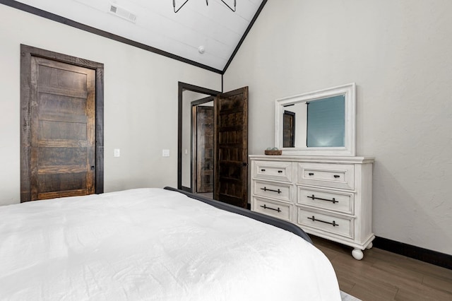 bedroom with lofted ceiling and dark hardwood / wood-style flooring