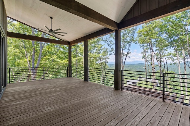 wooden terrace with a mountain view and ceiling fan