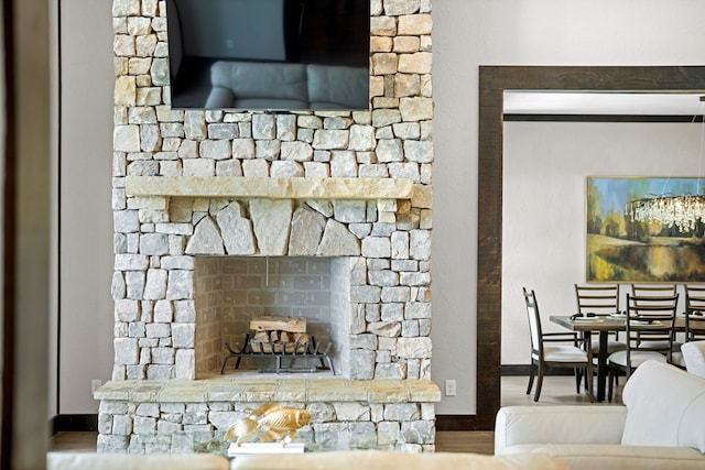 details with a stone fireplace and hardwood / wood-style flooring