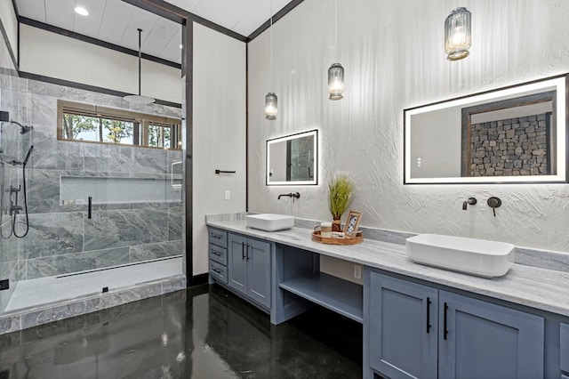 bathroom with vanity, a shower with shower door, and concrete flooring