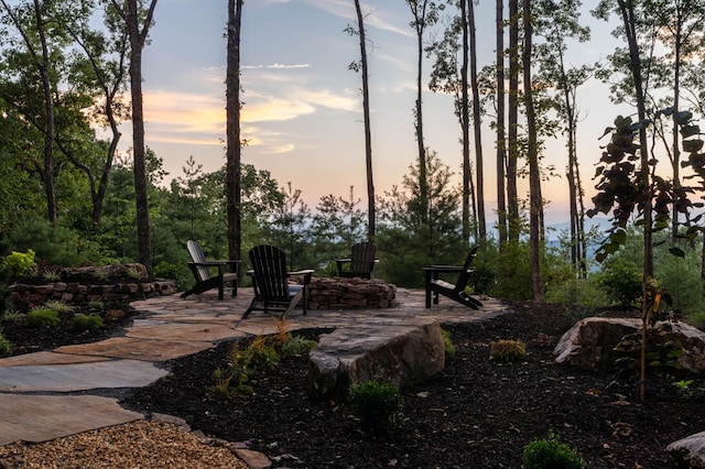 patio terrace at dusk featuring an outdoor fire pit