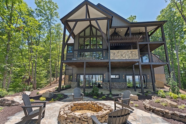 rear view of house featuring a patio and a fire pit