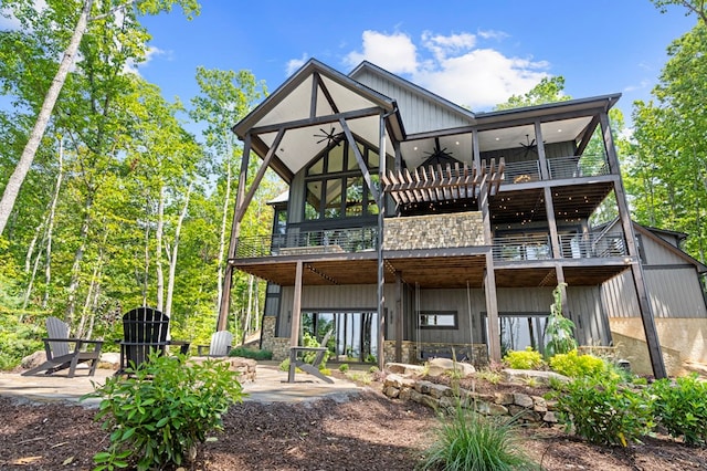 rear view of house with a balcony and a patio