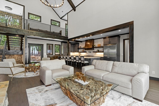 living room featuring high vaulted ceiling, beamed ceiling, and light wood-type flooring