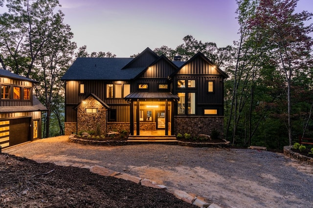 modern inspired farmhouse featuring covered porch and a garage