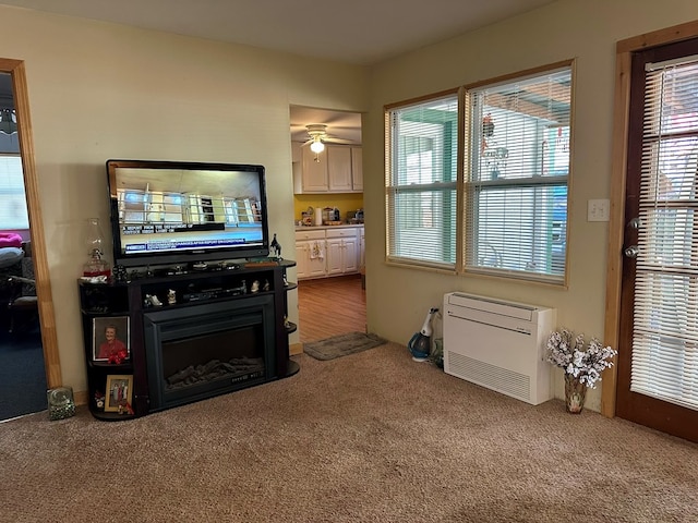 carpeted living room featuring ceiling fan