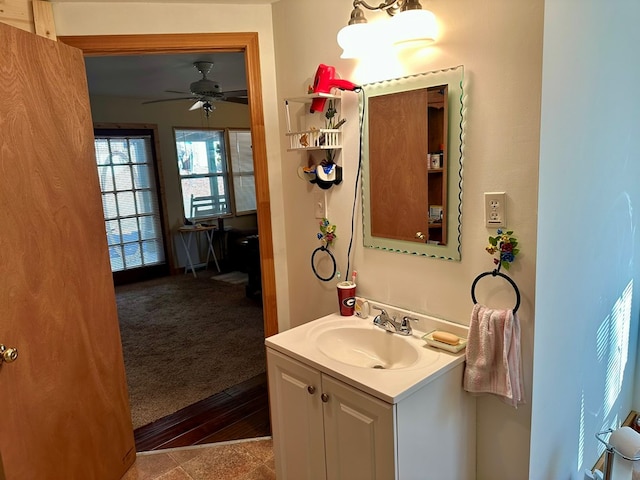 bathroom with hardwood / wood-style floors, vanity, and ceiling fan