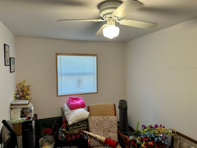 interior space with ceiling fan