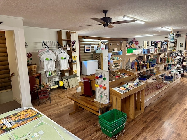 miscellaneous room with hardwood / wood-style flooring, ceiling fan, and a textured ceiling