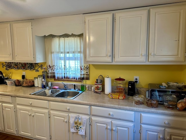 kitchen with white cabinetry and sink